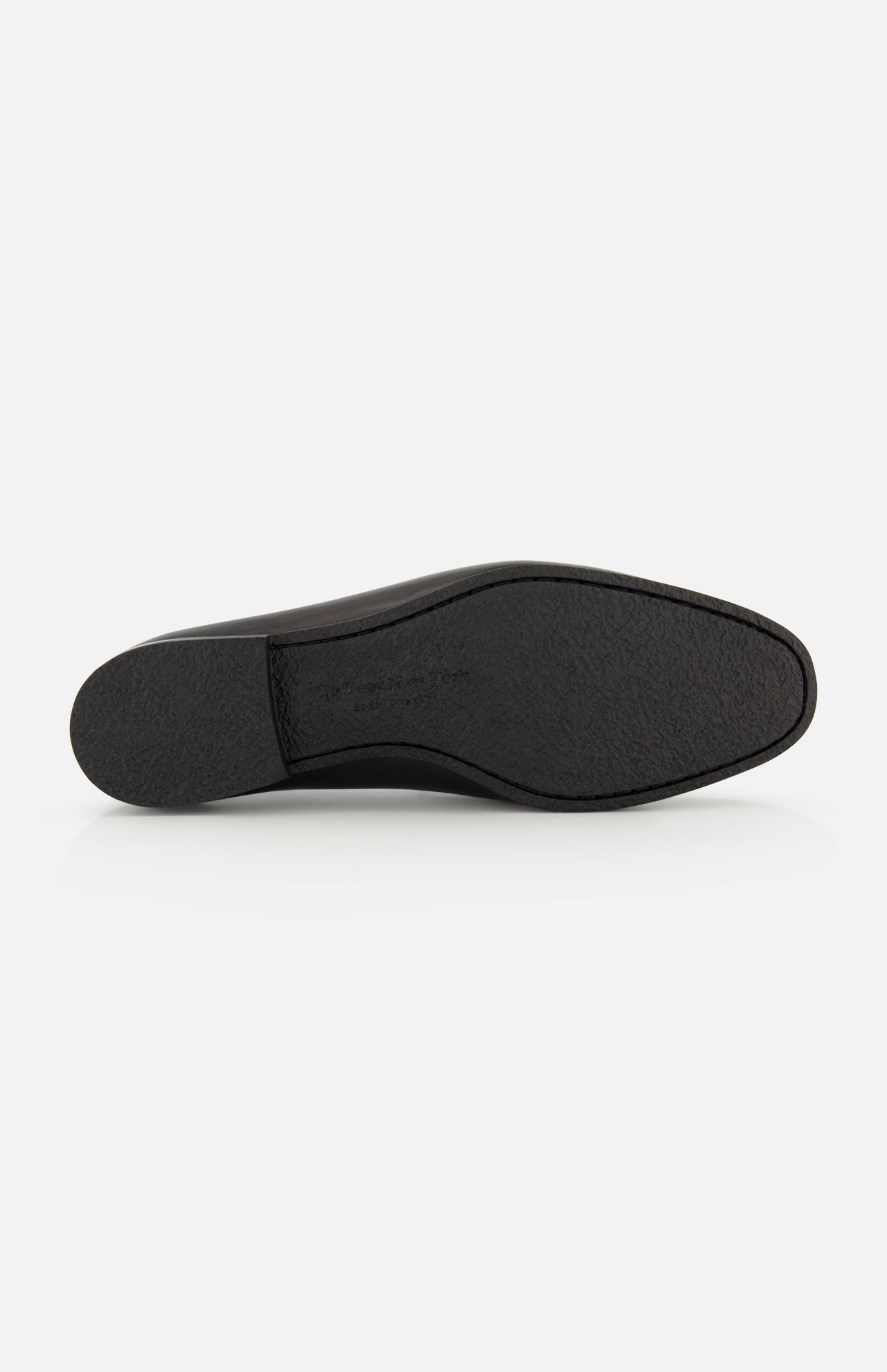 The image displays the black rubber sole of the TO BOOT Keats Leather Penny Loafer, viewed from underneath against a plain white background. The sole features a slightly textured finish and a low heel, reflecting the classic style of these leather loafers.