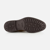 The image displays the sole of the TO BOOT Largo Suede Chelsea Boot for men—a dark brown suede Chelsea boot—featuring a patterned tread for grip, shown from the bottom against a plain white background.