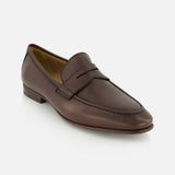 The Merritt Deer Leather Penny Loafer by TO BOOT, crafted from supple Italian deer leather with a low heel and moccasin-style toe, is displayed on a white background.