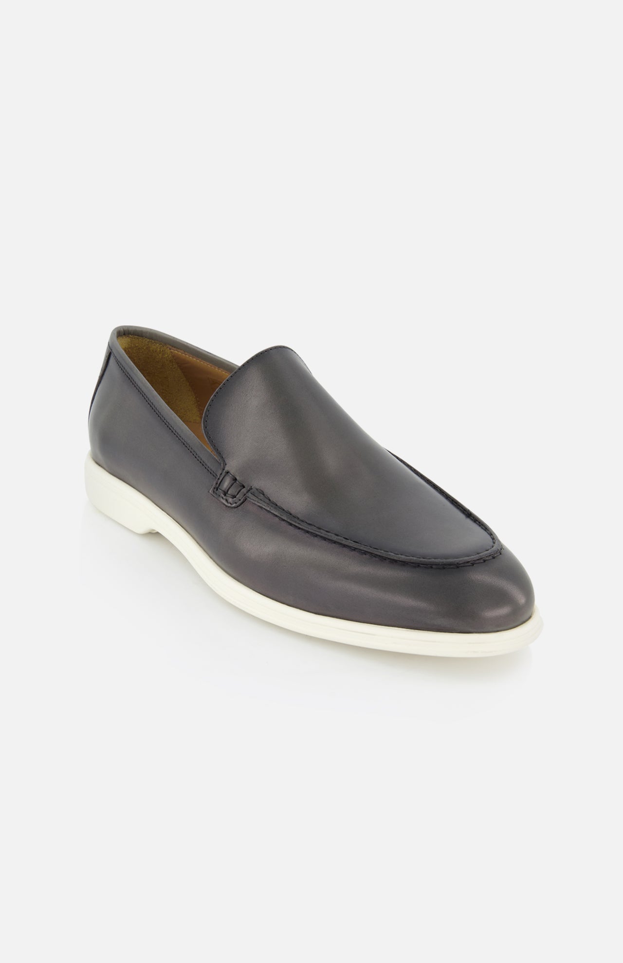 The TO BOOT Pacific Leather Hybrid Loafer is a black slip-on men's shoe with a white rubber sole and minimalist design, photographed at an angle on a white background—ideal for a modern, lace-free dress look.