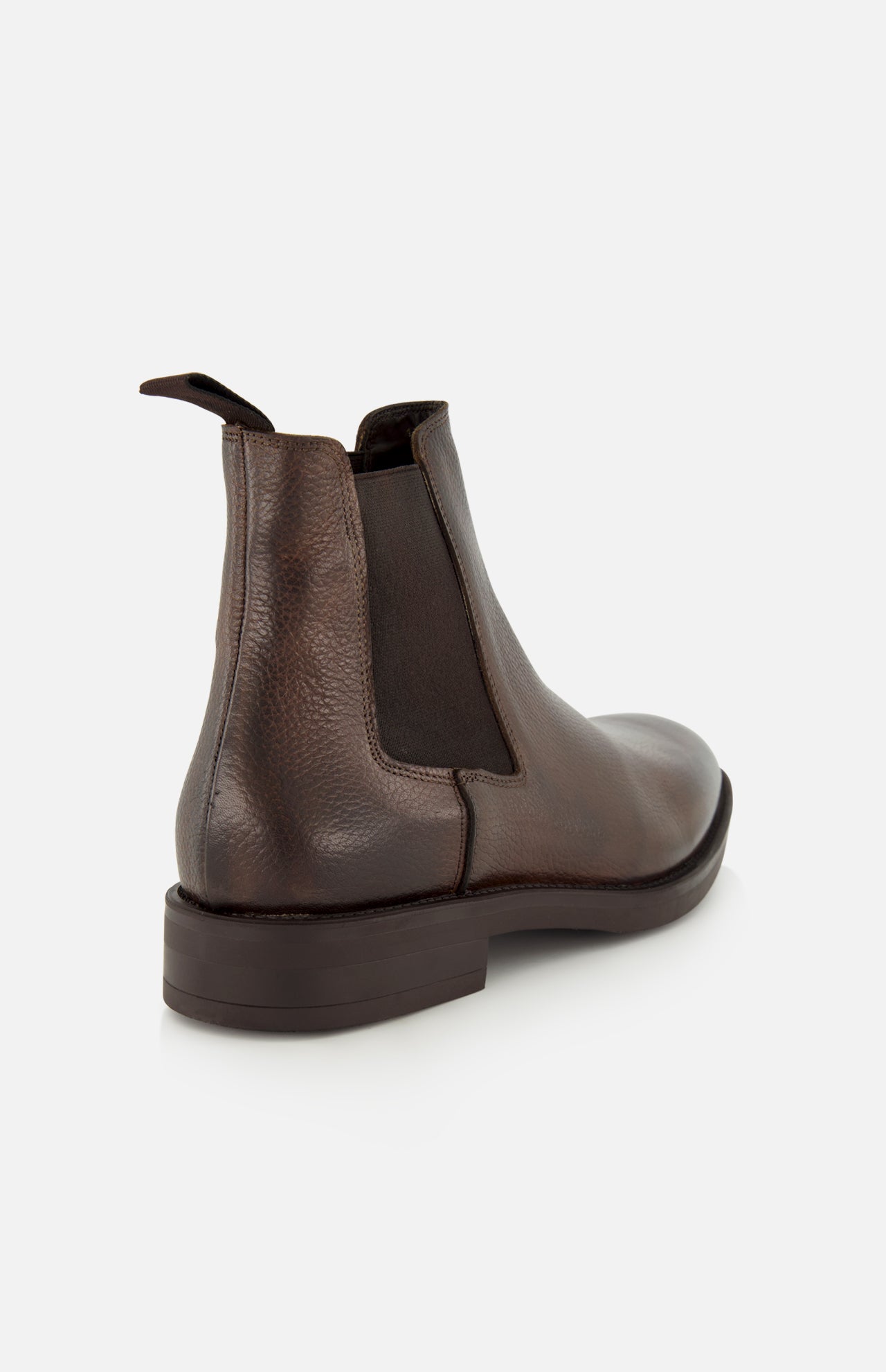 The Peabody Chelsea Boot by TO BOOT features brown grained leather, a rear pull tab, black elastic side panel, and dark sole—shown from a rear-side angle on white—perfect for fall.