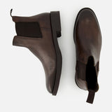 The Peabody Chelsea Boot by TO BOOT features brown grained leather, black elastic side panels, and pull tabs—shown from side and top views, these men’s fall boots are displayed on a white background.