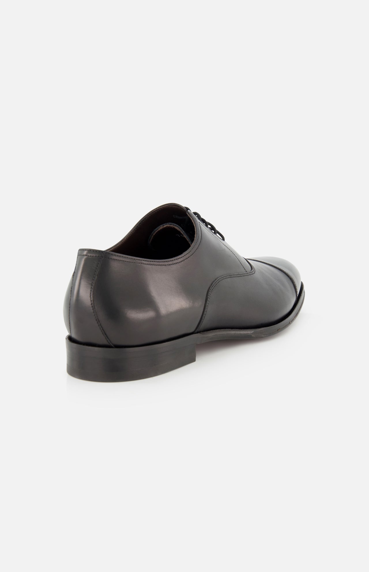 The Nico Leather Oxford by TO BOOT is shown from the back and side, featuring black hand-burnished leather, a smooth polished surface, low heel, and sleek design against a plain white background.