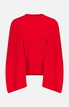 The TOTEME Crew Knit Cape Sweater is a bright red cashmere top with long, wide sleeves and ribbed hem and cuffs, shown on a plain white background.