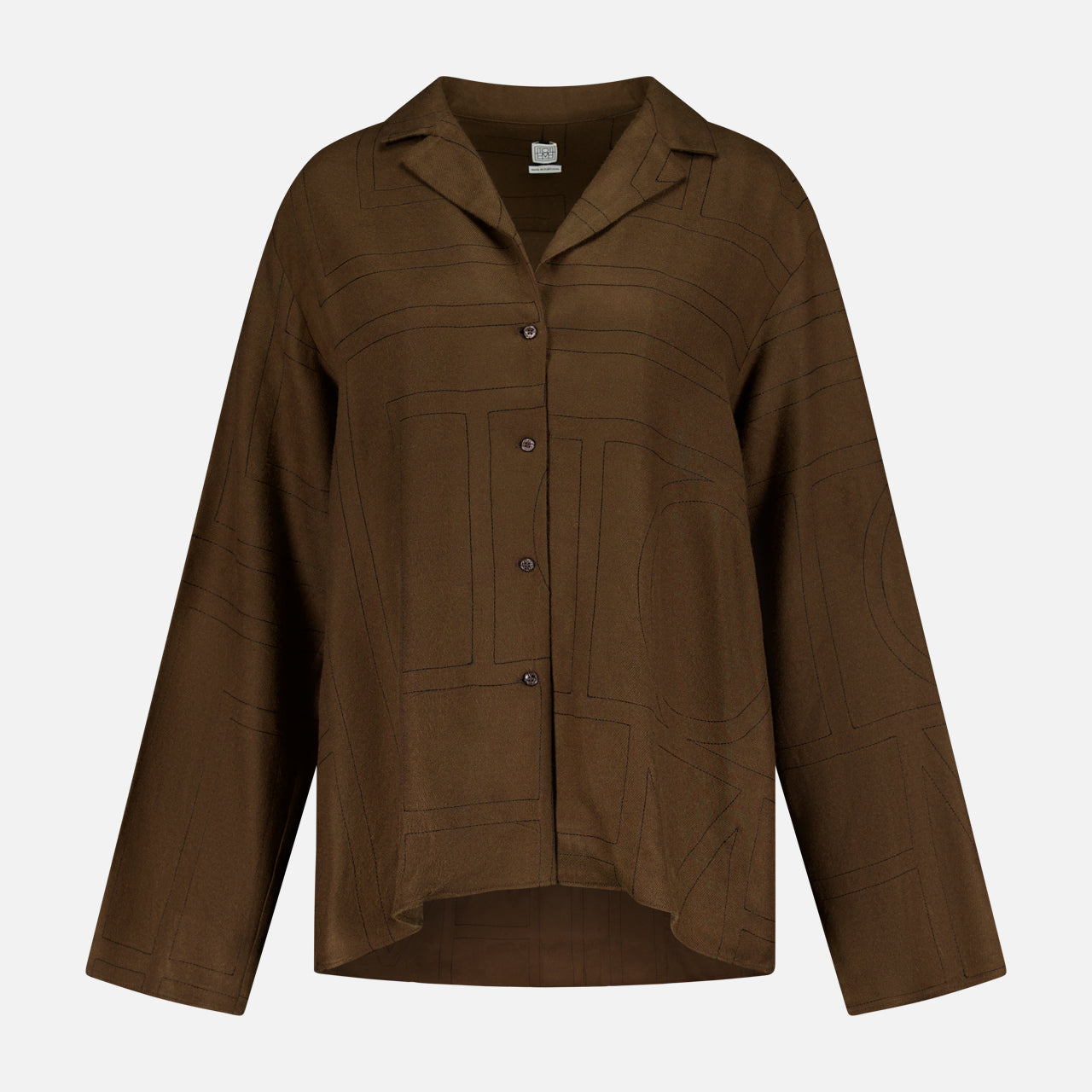 The TOTEME Monogram Flannel PJ Top is a dark brown shirt with a collar, relaxed silhouette, and subtle large geometric monogram-inspired patterns, shown on a plain white background.