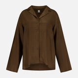 The TOTEME Monogram Flannel PJ Top is a dark brown shirt with a collar, relaxed silhouette, and subtle large geometric monogram-inspired patterns, shown on a plain white background.