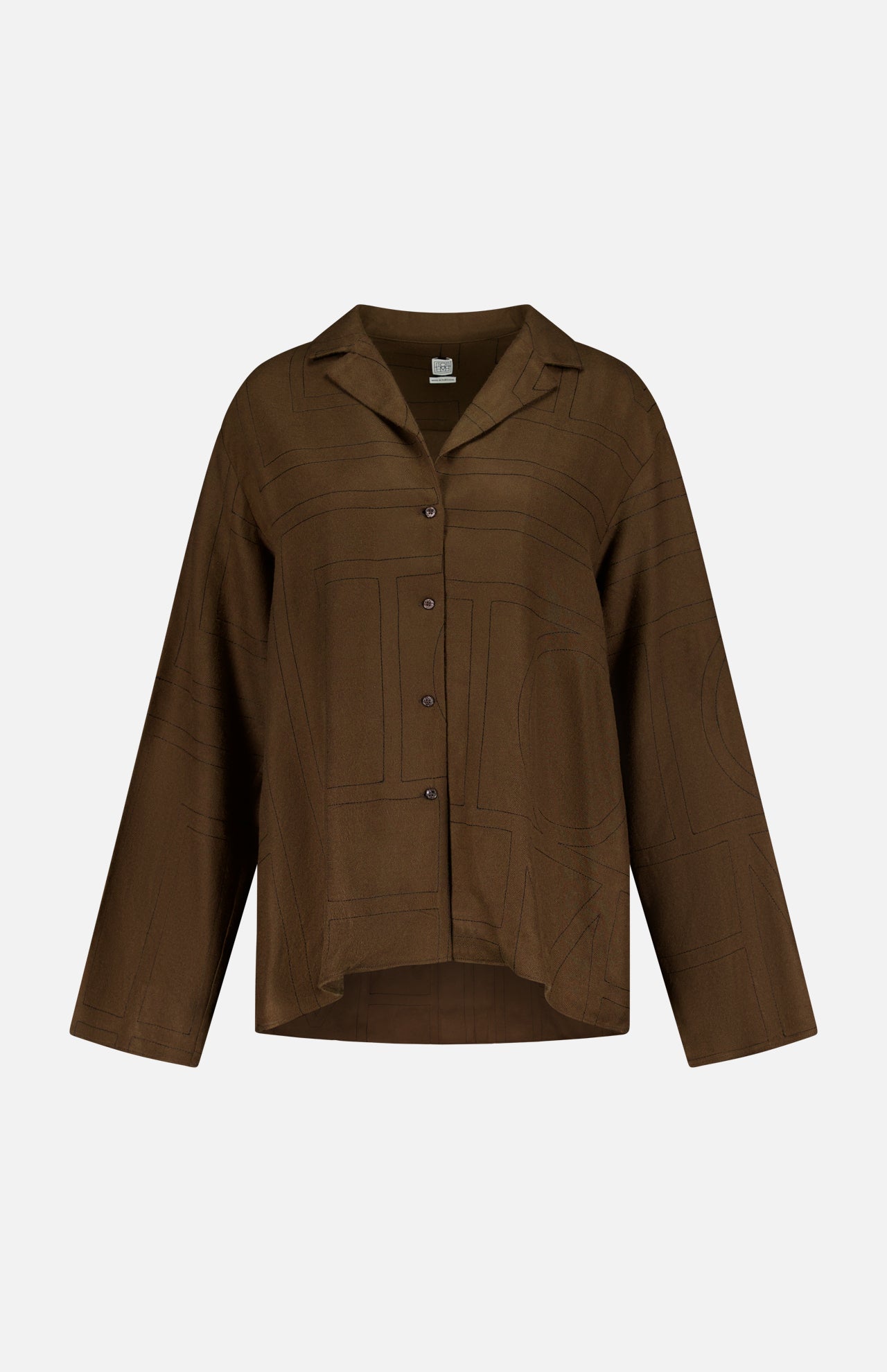 The TOTEME Monogram Flannel PJ Top is a dark brown shirt with a collar, relaxed silhouette, and subtle large geometric monogram-inspired patterns, shown on a plain white background.