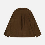 The TOTEME Monogram Flannel PJ Top is shown flat from the back in dark brown, featuring subtle geometric stitched patterns, a collar, and a loose, relaxed silhouette.