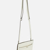 The TOTEME Belted Naplack Crossbody Bag, a slim rectangular white bag with a long adjustable strap and front pocket, made in Italy, is displayed against a plain white background.