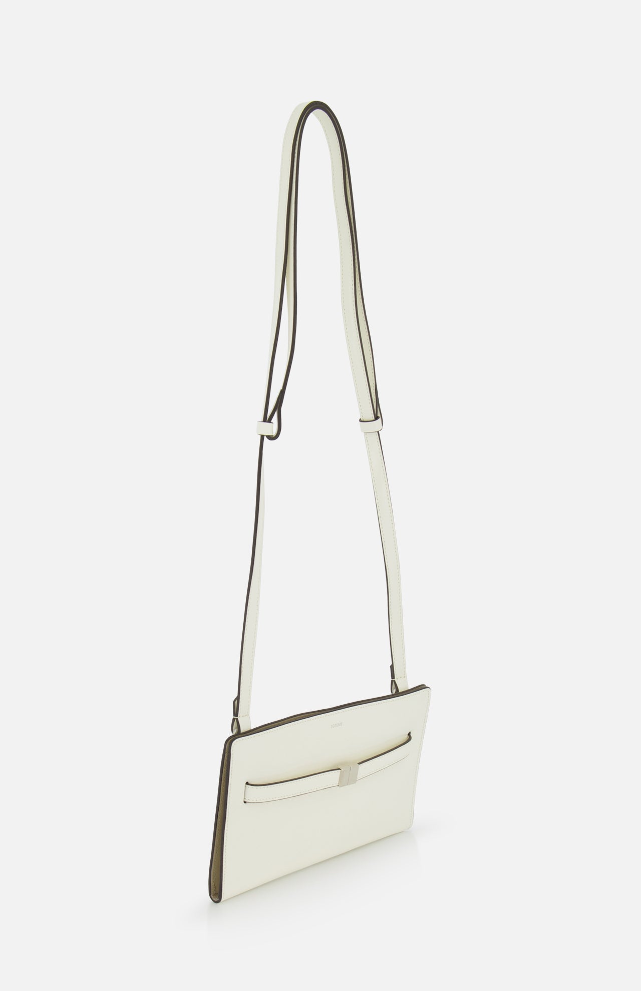 The TOTEME Belted Naplack Crossbody Bag, a slim rectangular white bag with a long adjustable strap and front pocket, made in Italy, is displayed against a plain white background.