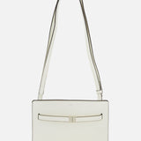 The TOTEME Belted Naplack Crossbody Bag is a minimalist white leather handbag with a long strap, subtle black trim, and a slim horizontal accent on the front. Made in Italy. Displayed against a plain white background.