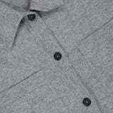 Close-up of the TOTEME Cashmere Long Sleeve Cardigan in grey, highlighting its button-front closure with black buttons, two chest pockets, classic collar, and the ultra-soft cashmere fabric texture.
