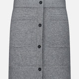 The TOTEME Buttoned Cashmere Skirt is a slim-fit, grey mini skirt designed with a front button-down closure and two large patch pockets, displayed against a plain white background.