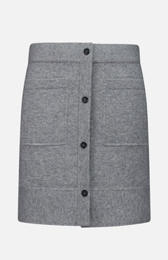 The TOTEME Buttoned Cashmere Skirt is a slim-fit, grey mini skirt designed with a front button-down closure and two large patch pockets, displayed against a plain white background.