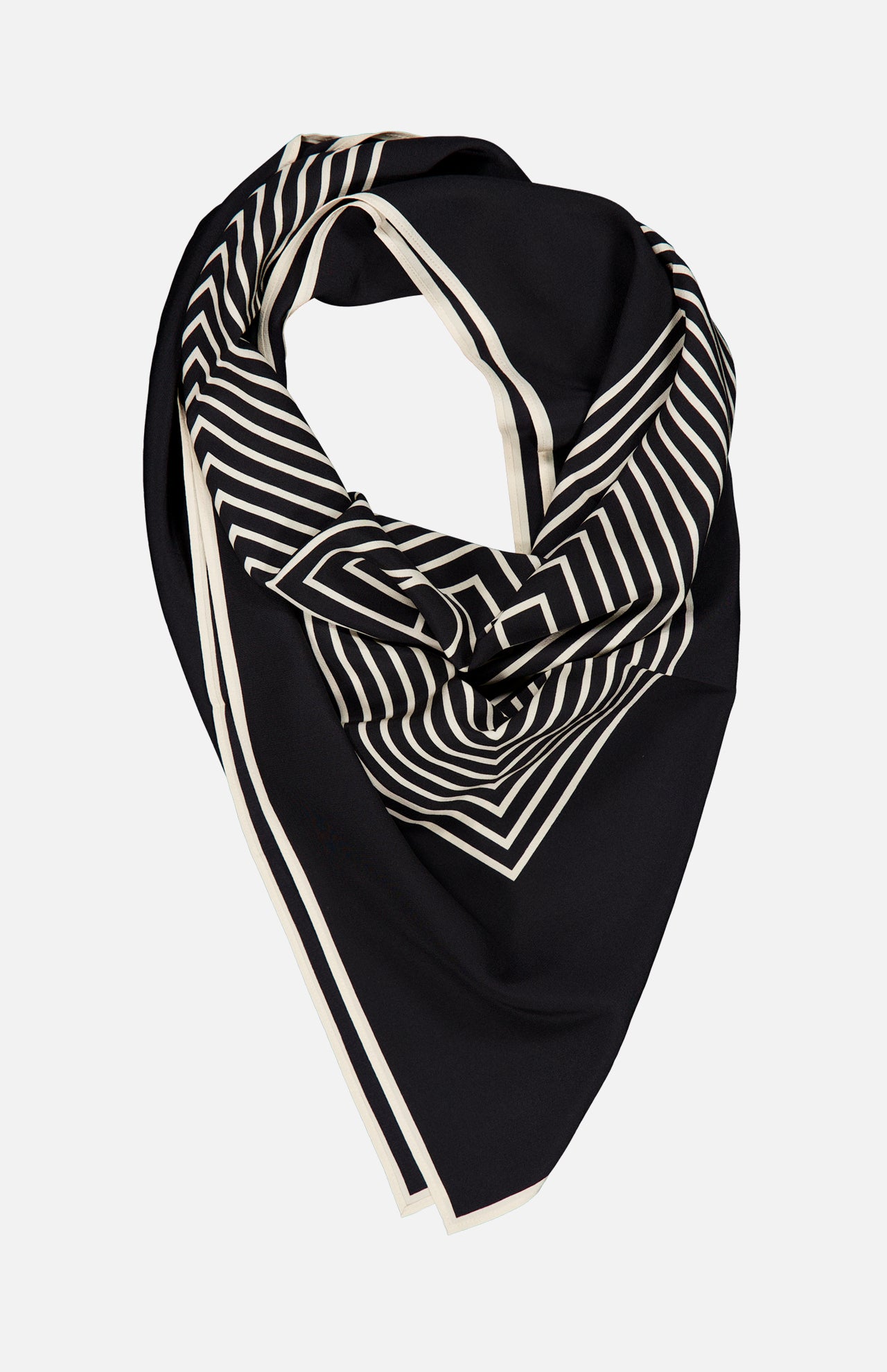 The TOTEME Centered Monogram Silk Scarf, featuring black silk adorned with white geometric stripes and borders, is elegantly arranged in a folded, slightly draped manner against a plain white background—a sophisticated women’s accessory perfect for elevating any look.