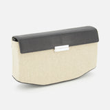 The TOTEME Clip Canvas Shoulder Bag is a rectangular clutch with a beige canvas and leather body, black textured flap, and a silver rectangular clasp on the front.