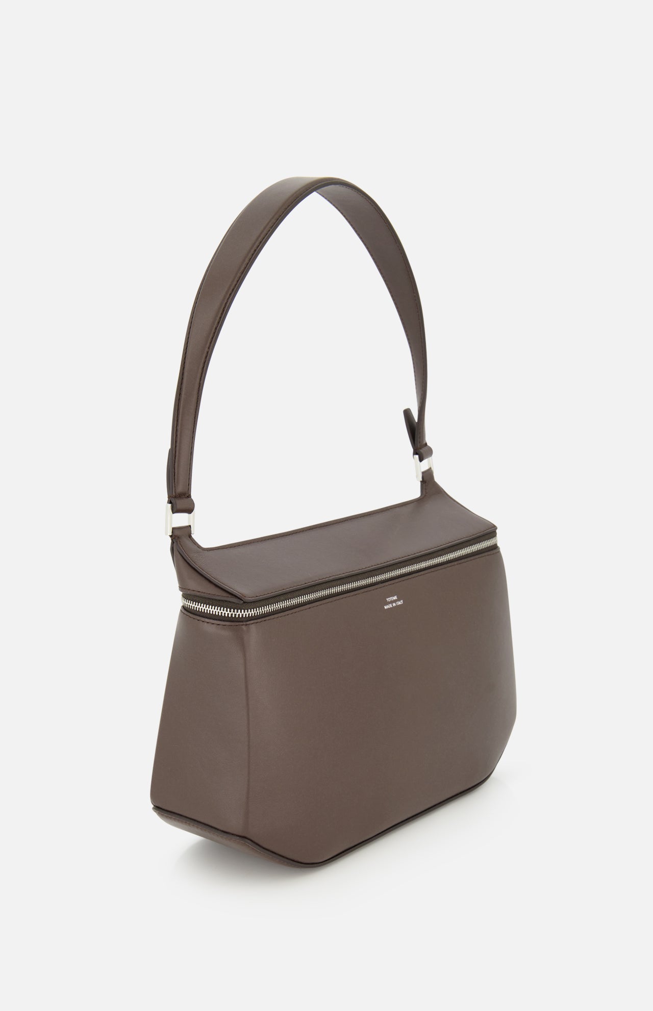 A TOTEME Clip Leather Shoulder Bag in dark brown leather, featuring a wide strap, silver zipper, and minimalist box bag design, is photographed against a plain white background.