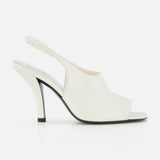 The TOTEME Contour Naplack Slingback Heel is a white leather peep-toe shoe with a curved high heel and black sole, shown against a white background.
