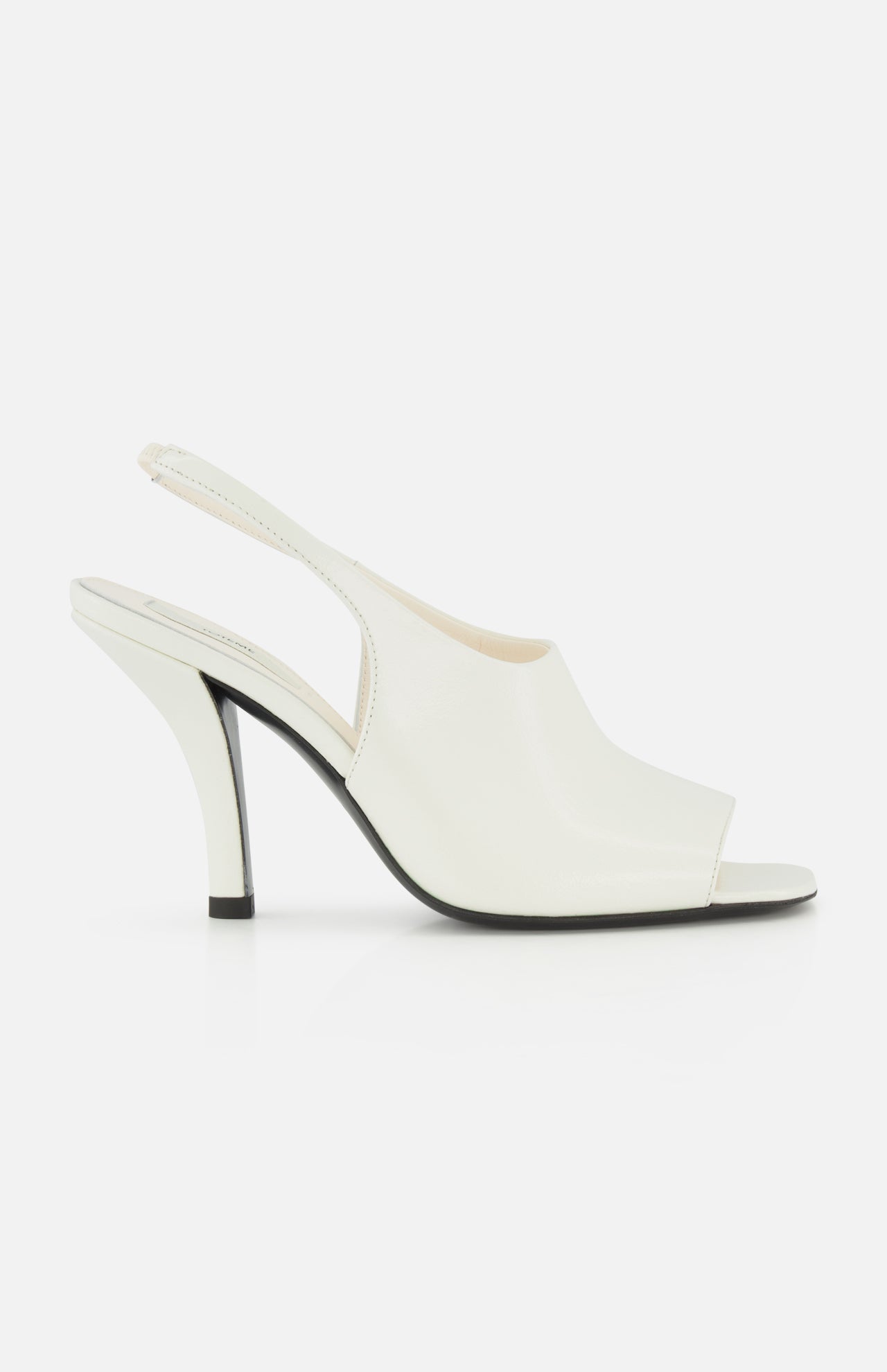 The TOTEME Contour Naplack Slingback Heel is a white leather peep-toe shoe with a curved high heel and black sole, shown against a white background.