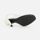 The TOTEME Contour Naplack Slingback Heel, featuring white leather and a black sole, is shown on its side to highlight the heel and bottom against a plain white background.