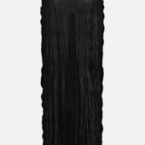 The TOTEME Crinkled Knit Pencil Skirt is a long black skirt with a sheer, crinkled texture, straight silhouette, and elastic waistband—ideal for chic monochrome outfits. Shown on a plain white background.