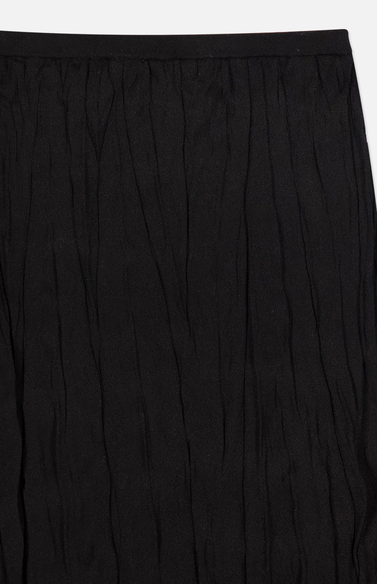 Close-up of TOTEME’s Crinkled Knit Pencil Skirt in black, featuring a subtle crinkled texture, vertical pleats, and a top waistband—ideal for a sleek monochromatic look.