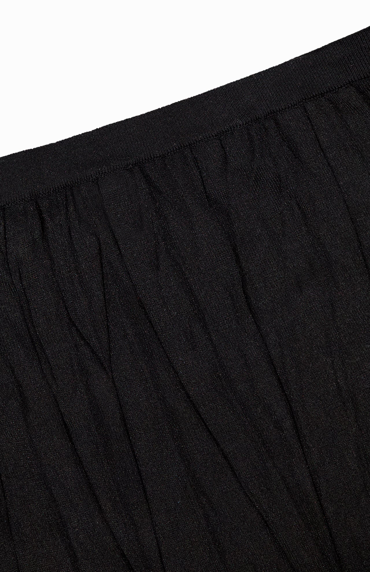 Close-up of the waistband and upper section of TOTEME's Crinkled Knit Pencil Skirt in black, made from lightweight fabric—ideal for achieving a sleek monochromatic look.