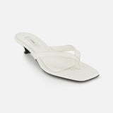 The TOTEME Croco Embossed Heeled Flip Flops feature white croc-embossed leather, a square toe, low black heel, and Italian craftsmanship, shown on a white background.