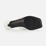 Bottom view of TOTEME’s Croco Embossed Heeled Flip Flops in white, featuring a black square-toed sole with a slightly raised heel and smooth finish. "Made in Italy" text is imprinted near the arch, showcasing its craftsmanship.