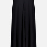 The TOTEME Flared Jersey Skirt is a black, ankle-length skirt with a high waist, center seam, and subtle front slit, shown against a plain white background.