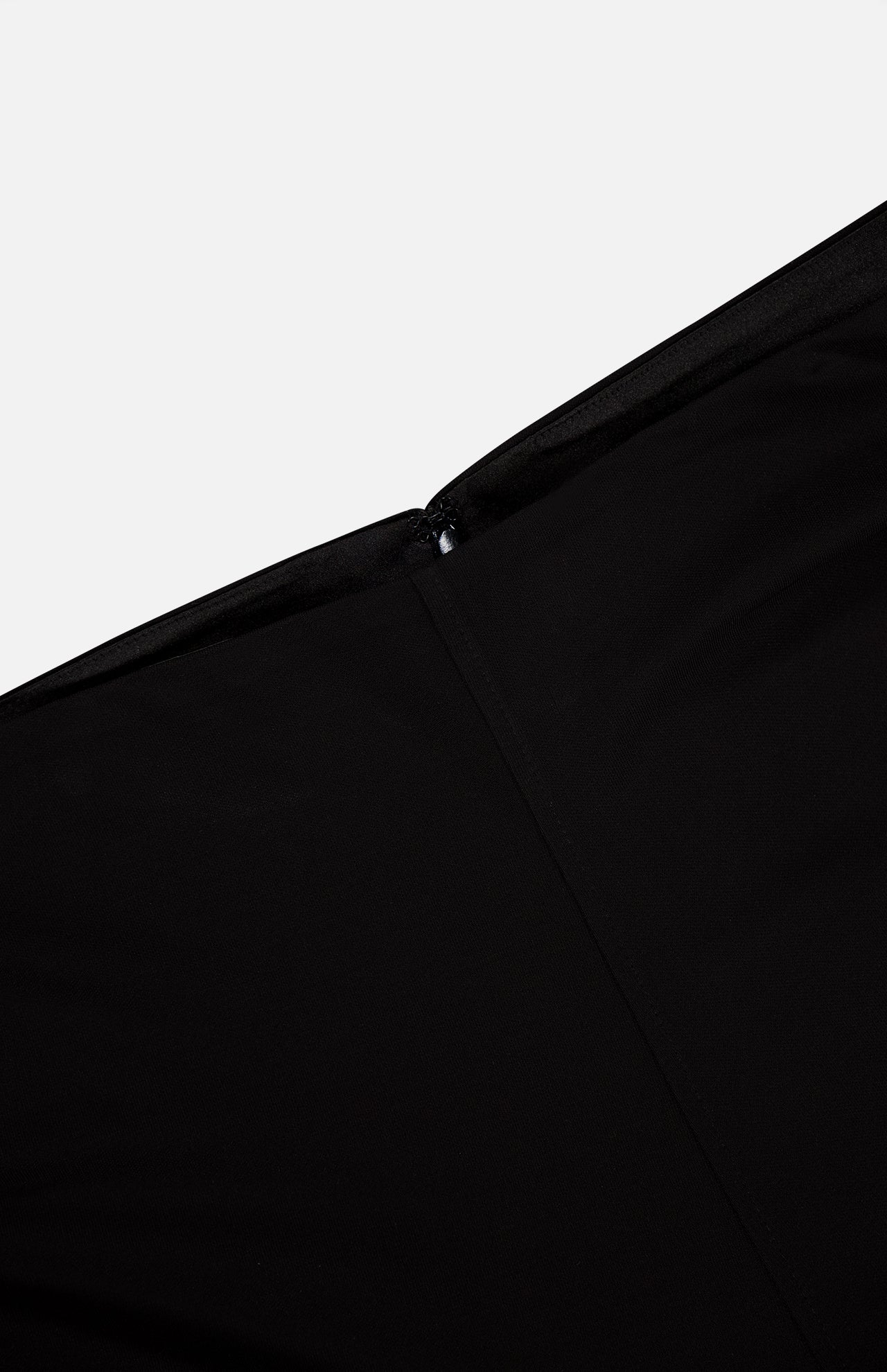 Close-up of TOTEME's Flared Jersey Skirt in black, highlighting its smooth, fabric texture and sleek finish against a plain white background.