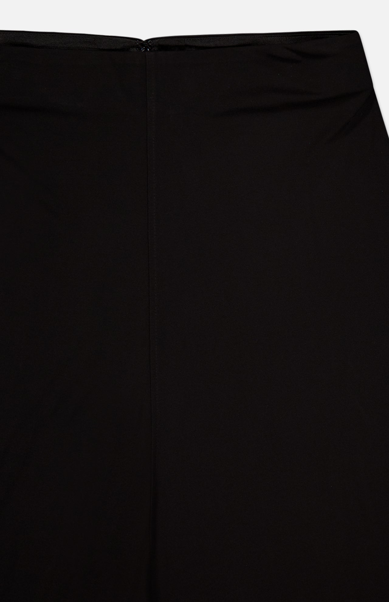 Close-up of the TOTEME Flared Jersey Skirt's back, showing its plain black design with a centered seam and an invisible zipper at the waistband.