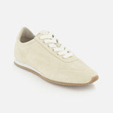 The TOTEME Flex Suede Low Profile Sneakers feature beige suede, white laces, a light brown rubber sole, and a minimalist design. Made in Italy, these sneakers are showcased on a plain white background.