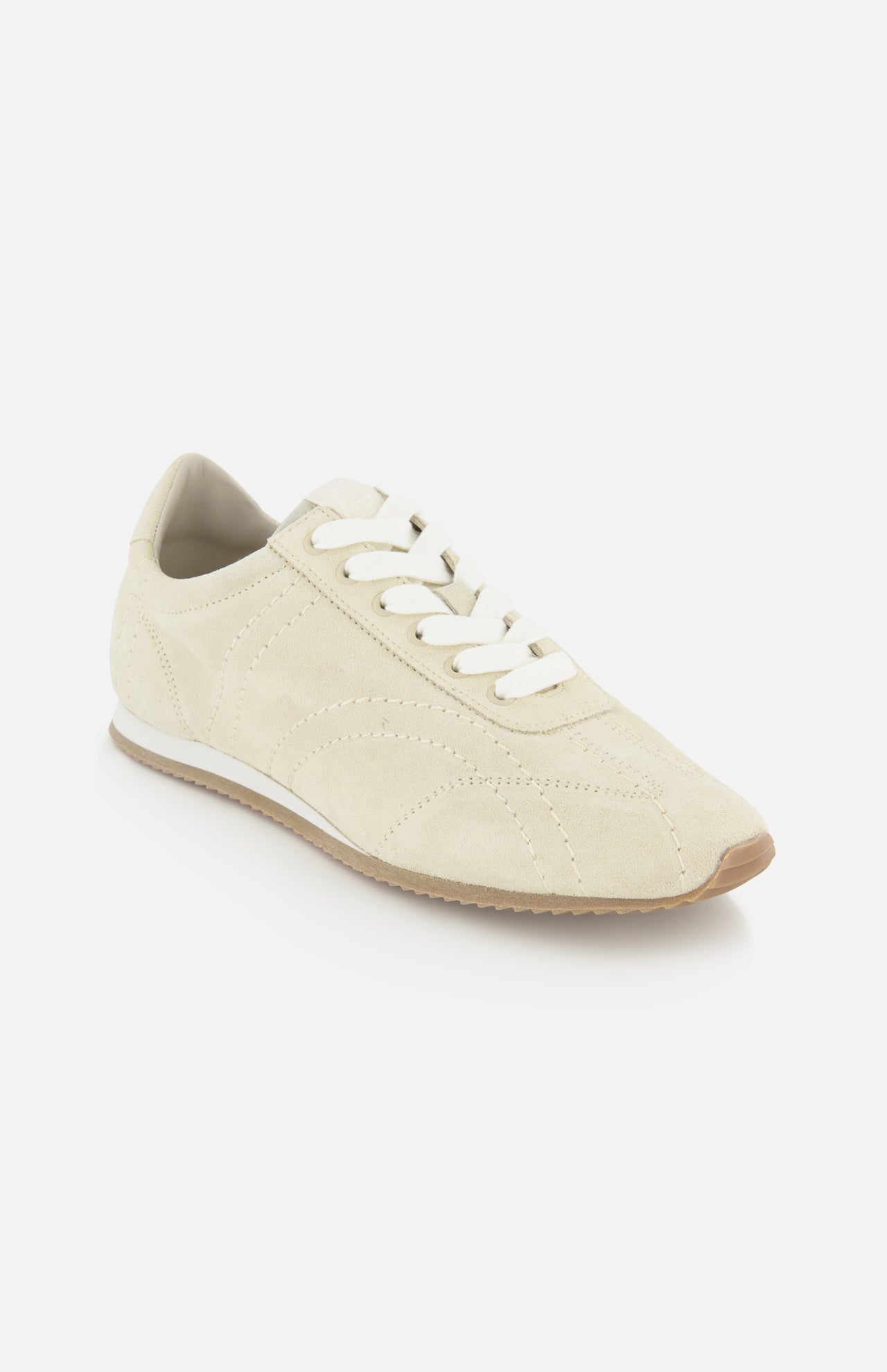 The TOTEME Flex Suede Low Profile Sneakers feature beige suede, white laces, a light brown rubber sole, and a minimalist design. Made in Italy, these sneakers are showcased on a plain white background.