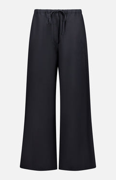 TOTEME Fluid Drawstring Trouser Pants in black, crafted from a lyocell-linen blend with wide legs, an elastic waistband, and drawstring waist, shown against a plain white background.