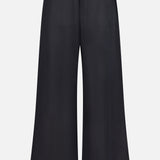 The TOTEME Fluid Drawstring Trouser Pants are wide-leg black summer trousers with a comfy drawstring waist and two large back pockets, crafted from a lyocell-linen blend and shown against a white background.