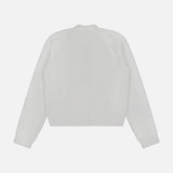 A plain white long-sleeve cardigan from TOTEME, the Hammered Button Cotton Cardigan, is laid flat with the back view visible against a light gray background. The cardigan features a crew neckline along with ribbed cuffs and hem, offering a classic cotton design.