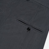 Close-up of the back pocket on TOTEME’s High-Waisted Trouser Pants in dark grey, showcasing a single black button and belt loops at the waistband. These office pants feature a sleek, high-rise fit for a polished appearance.