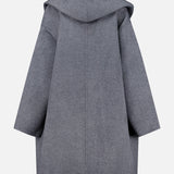 A back view of the TOTEME Wool Hoodie Coat in grey, featuring wide sleeves and a loose, oversized fit, displayed against a plain white background.