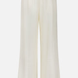 The TOTEME Monogram Silk PJ Bottoms are wide-leg, high-waisted ivory trousers with an elastic waistband, crafted from lightweight silk and detailed with a subtle embroidered monogram, shown against a plain white background.