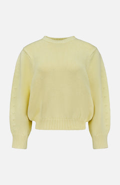 The TOTEME Oversized Crewneck Knit Sweater in butter yellow features long sleeves and a ribbed crew neckline, cuffs, and hem, shown against a plain white background.