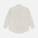 Back view of the TOTEME Oversized Pastel Striped Shirt, showcasing light blue and yellow stripes on white, a center box pleat, and buttoned cuffs.