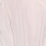 A close-up view of the TOTEME Silk-blend Parachute Skirt in pale pink, featuring a textured finish and a concealed top-center zipper.