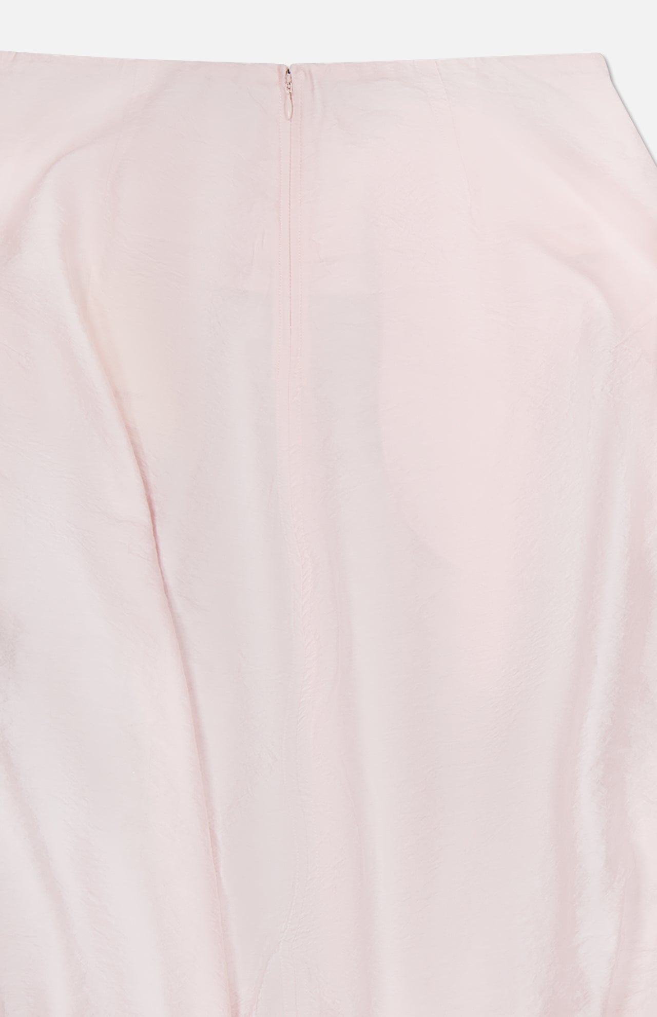 A close-up view of the TOTEME Silk-blend Parachute Skirt in pale pink, featuring a textured finish and a concealed top-center zipper.