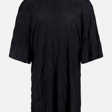 The TOTEME Relaxed Crinkle T-shirt Dress is an oversized black dress made from textured jersey, shown against a plain white background.