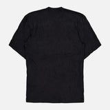 The TOTEME Relaxed Crinkle T-shirt Dress is shown from the back, laid flat on a white background. Its black, crinkled jersey fabric and oversized fit create an effortless, casual look.
