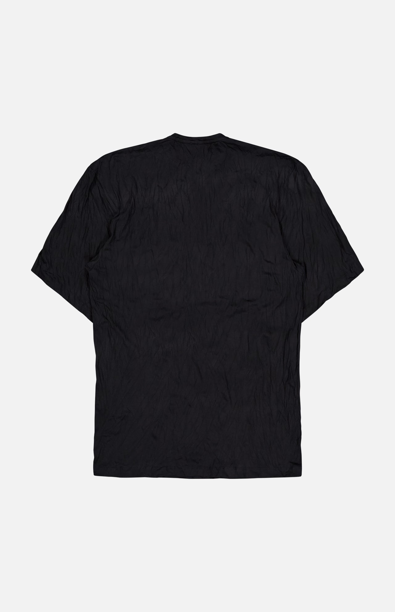 The TOTEME Relaxed Crinkle T-shirt Dress is shown from the back, laid flat on a white background. Its black, crinkled jersey fabric and oversized fit create an effortless, casual look.