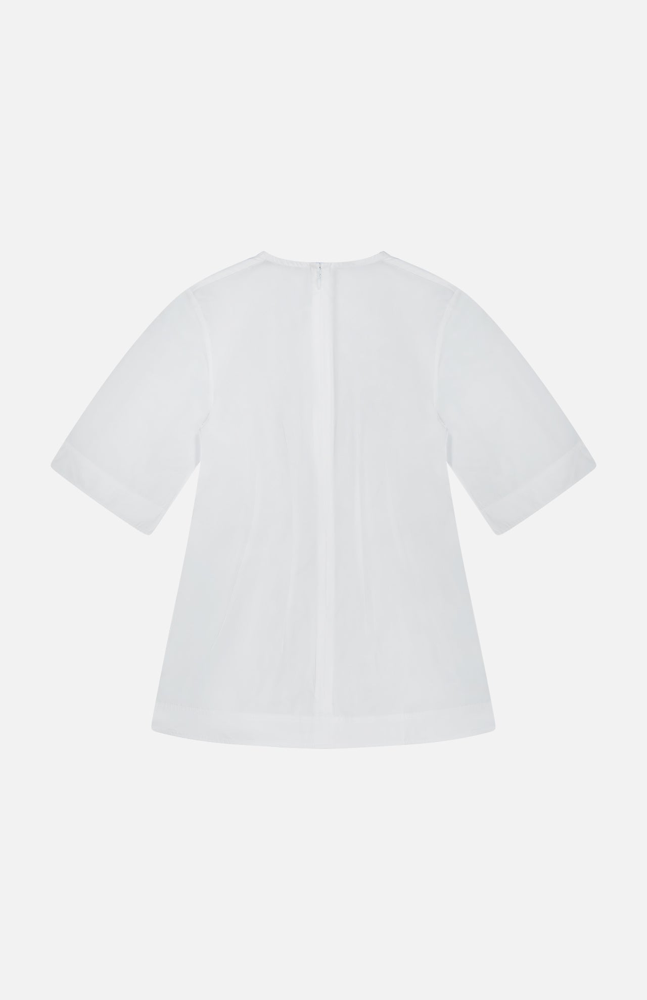 Back view of the TOTEME Sculptural Cotton Top in plain white, showcasing short sleeves and a central zipper. This designer blouse features a loose, subtly flared silhouette with a minimalist design, presented against a white background.