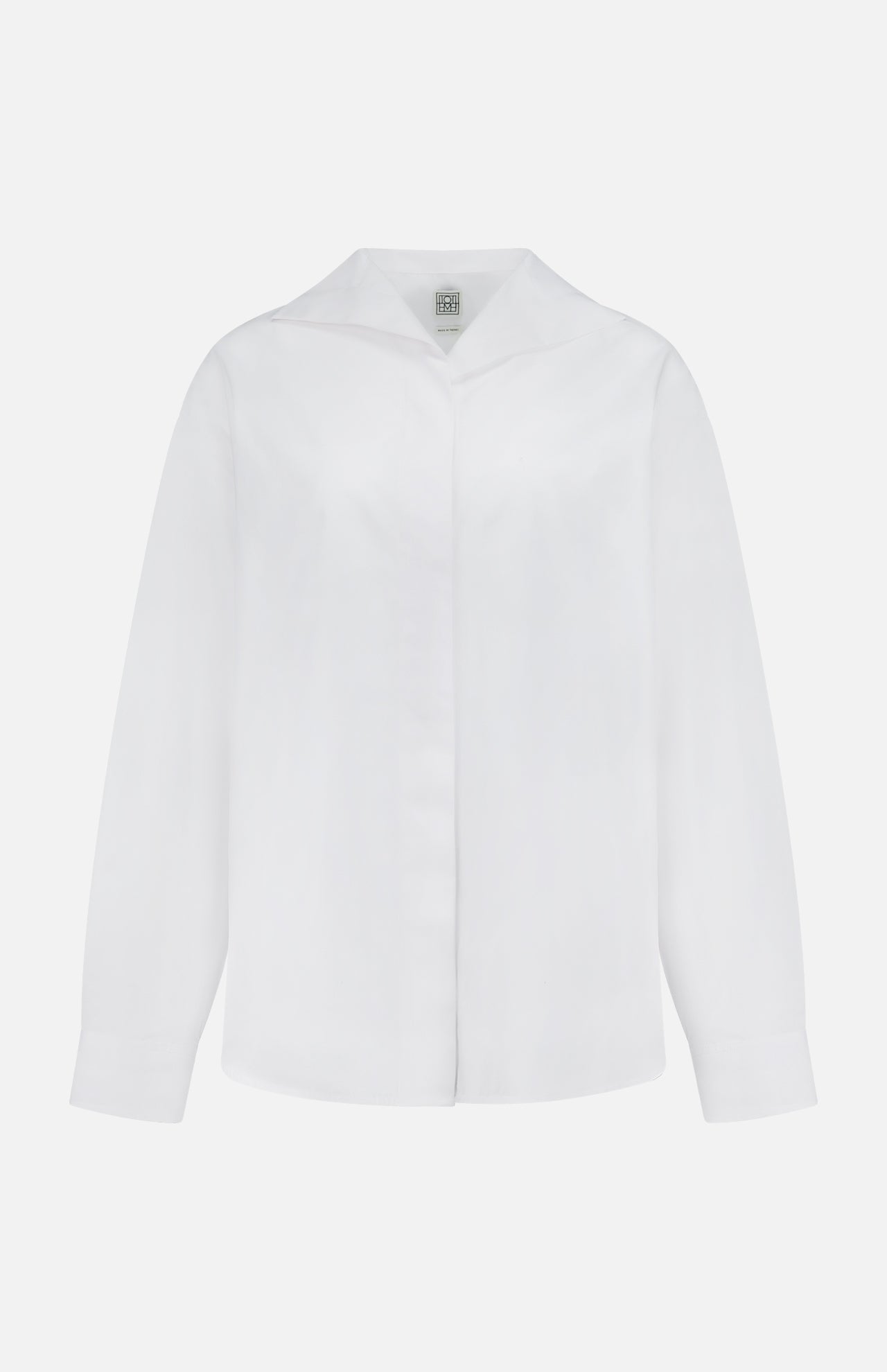 The TOTEME Sharp Poplin Dress Shirt is a white, long-sleeved cotton shirt with a collar and concealed buttons in a relaxed fit, shown against a plain white background.