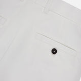 Close-up of the back of TOTEME's Single Pleat Cotton Trouser Pants, featuring belt loops, a single back pocket with a black button, and clean stitching detail.